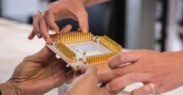 2 people passing computer processor between each other